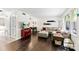 Inviting living room with hardwood floors, a sectional sofa, and view into dining area at 4605 Hedgemore Dr # I, Charlotte, NC 28209