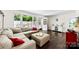 Comfortable living room featuring a large sectional sofa, ottoman, and ample natural light at 4605 Hedgemore Dr # I, Charlotte, NC 28209