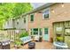 Charming brick patio with cozy seating, grill, and a view of the two-story brick home at 4607 Hedgemore Dr # H, Charlotte, NC 28209