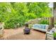 Cozy brick patio with stylish seating, fire pit, grill, and lush greenery, perfect for outdoor enjoyment at 4607 Hedgemore Dr # H, Charlotte, NC 28209
