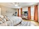 Bedroom with neutral walls, ceiling fan, hardwood floors, windows with valances, and exercise equipment at 4607 Hedgemore Dr # H, Charlotte, NC 28209