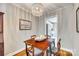 Dining area featuring wooden table and chairs, chandelier, and a view into an adjacent space at 4607 Hedgemore Dr # H, Charlotte, NC 28209