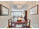 Formal dining area showcases elegant decor, a chandelier, and seamless flow into an inviting living space at 4607 Hedgemore Dr # H, Charlotte, NC 28209