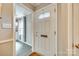 Welcoming foyer featuring a white front door with a leaded glass window and a view into the kitchen at 4607 Hedgemore Dr # H, Charlotte, NC 28209