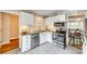 Well-lit kitchen boasts white cabinetry, stainless steel appliances, and complementing tile backsplash at 4607 Hedgemore Dr # H, Charlotte, NC 28209