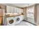 Bright kitchen featuring stainless steel appliances, granite countertops, and a convenient washer and dryer at 4607 Hedgemore Dr # H, Charlotte, NC 28209