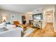 Cozy living room featuring hardwood floors, stylish decor, and easy access to dining area and front entrance at 4607 Hedgemore Dr # H, Charlotte, NC 28209