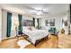 Spacious main bedroom featuring hardwood floors, large windows with dark green curtains, and modern decor at 4607 Hedgemore Dr # H, Charlotte, NC 28209