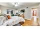 Comfortable main bedroom with hardwood floors, large bed, and a sitting area for relaxation at 4607 Hedgemore Dr # H, Charlotte, NC 28209