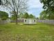 Large backyard featuring privacy fence, and a wooden storage shed at 4623 Monmouth Dr, Charlotte, NC 28269