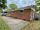 Exterior side view of a brick house showing a patio and utilities at 4623 Monmouth Dr, Charlotte, NC 28269