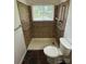 Accessible shower with tiled surround, grab bars, and modern fixtures in bathroom at 4623 Monmouth Dr, Charlotte, NC 28269