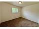 This carpeted bedroom has a window and neutral paint at 4623 Monmouth Dr, Charlotte, NC 28269