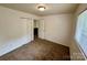 This carpeted bedroom has a closet, fresh paint, and a view to the hallway at 4623 Monmouth Dr, Charlotte, NC 28269