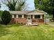 Charming brick home with white shutters and a well-maintained lawn, a cozy welcome for potential buyers at 4623 Monmouth Dr, Charlotte, NC 28269