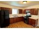 Efficient kitchen with wood cabinets, modern appliances, and a tile floor at 4623 Monmouth Dr, Charlotte, NC 28269