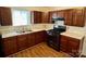 The kitchen features wood cabinets, light countertops, stainless steel sink and a black gas range at 4623 Monmouth Dr, Charlotte, NC 28269