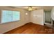 Spacious living room with hardwood floors, a ceiling fan, and a bright window at 4623 Monmouth Dr, Charlotte, NC 28269