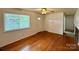 Cozy living room featuring hardwood floors, a ceiling fan, and a front-facing window at 4623 Monmouth Dr, Charlotte, NC 28269
