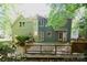 Exterior view of the home featuring a large wooden back deck, trees, and brick path at 4704 Beech Crest Pl, Charlotte, NC 28269