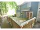 View of a large wooden back deck and blue house siding surrounded by trees at 4704 Beech Crest Pl, Charlotte, NC 28269