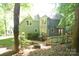 Backyard view featuring a spacious wooden deck and lush greenery, perfect for outdoor living and entertaining at 4704 Beech Crest Pl, Charlotte, NC 28269