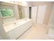 Spacious bathroom offers a long white vanity with dual sinks and large mirror at 4704 Beech Crest Pl, Charlotte, NC 28269