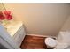 Powder room featuring a toilet, vanity, mirror and decorative flowers at 4704 Beech Crest Pl, Charlotte, NC 28269