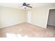 Spacious carpeted bedroom with ceiling fan and natural light at 4704 Beech Crest Pl, Charlotte, NC 28269