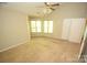 Carpeted bedroom offers ceiling fan, natural light, and ample space at 4704 Beech Crest Pl, Charlotte, NC 28269