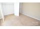 Bedroom with neutral walls and carpet features a closet and white trim at 4704 Beech Crest Pl, Charlotte, NC 28269
