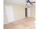 Carpeted bedroom with neutral walls features ceiling fan and two doors at 4704 Beech Crest Pl, Charlotte, NC 28269