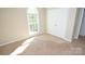 Bright bedroom with a large window, closet, and neutral walls and carpet at 4704 Beech Crest Pl, Charlotte, NC 28269