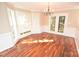 Bright dining room with hardwood floors, chandelier, chair rail and French doors at 4704 Beech Crest Pl, Charlotte, NC 28269