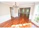 Open dining room with hardwood floors, a chandelier and lots of natural light with backyard view at 4704 Beech Crest Pl, Charlotte, NC 28269