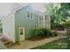 Exterior view showcasing a charming house with a brick walkway, well-maintained garden, and a private entrance at 4704 Beech Crest Pl, Charlotte, NC 28269