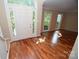 Bright foyer with hardwood floors, large windows and a white front door with sidelights at 4704 Beech Crest Pl, Charlotte, NC 28269
