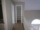 A carpeted hallway with storage space and natural light pouring through front door at 4704 Beech Crest Pl, Charlotte, NC 28269