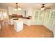 Updated kitchen with white cabinetry, an island, and eat in area with large windows at 4704 Beech Crest Pl, Charlotte, NC 28269
