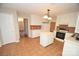 Kitchen boasts an island, white cabinets and appliances, and tile backsplash at 4704 Beech Crest Pl, Charlotte, NC 28269
