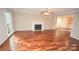 Spacious living room with hardwood floors, a fireplace, ceiling fan and natural light at 4704 Beech Crest Pl, Charlotte, NC 28269