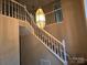 Carpeted staircase featuring a decorative light fixture and white railing at 4704 Beech Crest Pl, Charlotte, NC 28269