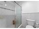Tiled bathroom with glass-enclosed shower, toilet, and built-in shelving; clean and functional design at 4931 Pine Ridge Rd, Charlotte, NC 28226
