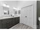 Bathroom with dual vanity sinks, large mirrors, and neutral colors at 4931 Pine Ridge Rd, Charlotte, NC 28226