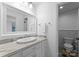 Bathroom with a marble countertop vanity, decorative mirror, and well-maintained fixtures at 4931 Pine Ridge Rd, Charlotte, NC 28226