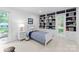 Charming bedroom with a single bed, built-in shelving, and a bright window with a lush view at 4931 Pine Ridge Rd, Charlotte, NC 28226