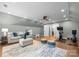 Spacious bonus room with hardwood floors, television, and natural light at 4931 Pine Ridge Rd, Charlotte, NC 28226