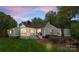 Inviting backyard with a cozy patio, fire pit, well-maintained lawn, and a charming screened-in porch at 4931 Pine Ridge Rd, Charlotte, NC 28226