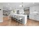 Bright, modern kitchen featuring a large center island with seating and stainless steel appliances at 4931 Pine Ridge Rd, Charlotte, NC 28226