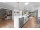 Open kitchen with a large island, stainless steel appliances, and an adjoining Gathering room at 4931 Pine Ridge Rd, Charlotte, NC 28226